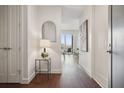 Hallway with dark wooden floor and a mirror on a side table at 1820 Peachtree Nw St # 1110, Atlanta, GA 30309