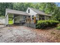 Exterior view of home with covered parking, deck, and mature landscaping at 1909 Moores Mill Nw Rd, Atlanta, GA 30318