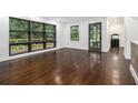 Bright living room featuring large windows, dark trim, and hardwood floors at 1909 Moores Mill Nw Rd, Atlanta, GA 30318