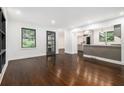 Inviting living room open to kitchen boasts hardwood floors and large windows at 1909 Moores Mill Nw Rd, Atlanta, GA 30318