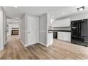 Modern kitchen with white cabinets, granite countertops, stainless steel appliances, and luxury vinyl plank flooring at 2638 Stoney Creek Rd, Marietta, GA 30067