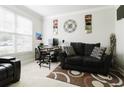 Comfortable home office with neutral walls, plush carpet, a window, and a cozy seating area at 3241 Alhambra Cir, Hampton, GA 30228