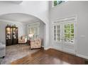 Bright foyer with hardwood floors, high ceilings, arched doorway, and double door entry allowing ample natural light at 1045 River Pt, Suwanee, GA 30024