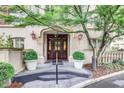 A welcoming building entrance with a beautiful wood door, planters, and architectural details at 1717 N Decatur Ne Rd # 303, Atlanta, GA 30307