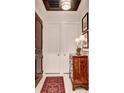 An inviting foyer with a classic rug, chest of drawers, and clean white closet doors at 1717 N Decatur Ne Rd # 303, Atlanta, GA 30307
