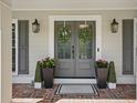 Stylish front door with sidelights, brick flooring, and decorative wreaths, creating curb appeal at 4824 Dunwoody Station Dr, Atlanta, GA 30338