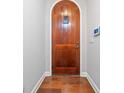 Entryway featuring an arched wood front door and hardwood floors at 620 Stickley Oak Way, Woodstock, GA 30189
