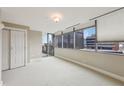 Serene bedroom with cityscape views through large windows, plush carpeting, and ample natural light at 700 Park Regency Ne Pl # 1203, Atlanta, GA 30326
