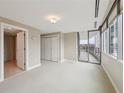 Cozy bedroom featuring balcony access, lots of natural light, and ample closet space at 700 Park Regency Ne Pl # 1203, Atlanta, GA 30326