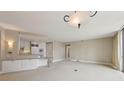 Bright, open-concept living space with modern lighting, neutral walls, and a seamless flow to the kitchen at 700 Park Regency Ne Pl # 1203, Atlanta, GA 30326