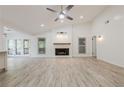 Inviting living room featuring a modern fireplace, light wood flooring, and French doors to the outdoors at 9985 Lake Forest Way, Roswell, GA 30076