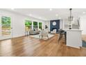 Spacious living room with hardwood floors, neutral decor, and a cozy fireplace with unique blue accent wall at 2813 Hillside Rd, Smyrna, GA 30080
