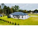 Expansive backyard with well-manicured lawn, patio and mature trees surrounding property at 2964 Old Peachtree Rd, Dacula, GA 30019