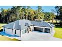 A stunning aerial view of a home with modern garages and long driveway at 2964 Old Peachtree Rd, Dacula, GA 30019