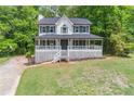 Attractive home with a large front yard and a welcoming, covered porch at 5139 Coolamber Dr, Powder Springs, GA 30127