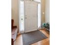 Inviting foyer featuring a white door, hardwood floors, and stylish accents at 6990 N Glen Dr, Cumming, GA 30028