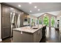 Gourmet kitchen features a large island, granite countertops, stainless appliances, and access to the living room at 2912 Dunhill Trl, Woodstock, GA 30189