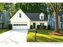 Inviting home with a neat lawn, white garage door, and a green front door at 3315 Haverhill Rowe, Lawrenceville, GA 30044