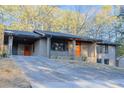 Well-maintained brick home with a covered carport, front porch, and a slightly sloping front yard at 4011 Lake Carlton Rd, Loganville, GA 30052
