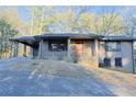 Well-maintained brick home with a covered carport, front porch, and a slightly sloping front yard at 4011 Lake Carlton Rd, Loganville, GA 30052