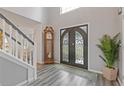 Grand foyer featuring an ornate front door, hardwood floors, and staircase at 6932 Dalehollow Dr, Lithonia, GA 30058