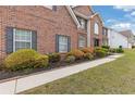 Charming brick home featuring a neatly landscaped front yard and walkway at 6932 Dalehollow Dr, Lithonia, GA 30058