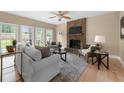 Cozy living room featuring a stone fireplace, hardwood floors, and a view of the backyard at 1130 Lochshyre Way, Lawrenceville, GA 30043