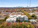 Scenic aerial view of community, showcasing lush landscaping, city skyline, and a sparkling pool at 130 Arizona Ne Ave # 104, Atlanta, GA 30307