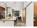 Open concept kitchen with granite island, stainless appliances, and view to the living space at 130 Arizona Ne Ave # 104, Atlanta, GA 30307