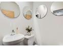 Stylish powder room featuring a vessel sink, decorative mirrors, and minimalist design at 130 Arizona Ne Ave # 104, Atlanta, GA 30307