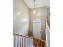 Bright entryway featuring a white front door, wood floors and a light fixture at 1358 Stoneleigh Way, Stone Mountain, GA 30088