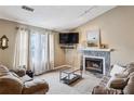 Comfortable living room includes a fireplace, a large window and neutral decor at 1358 Stoneleigh Way, Stone Mountain, GA 30088