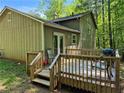 View of the deck featuring outdoor furniture, perfect for relaxing or entertaining surrounded by mature trees at 3832 Natalie Way, Ellenwood, GA 30294
