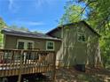 Back exterior featuring a wooden deck with patio furniture, perfect for outdoor entertaining and enjoying the backyard at 3832 Natalie Way, Ellenwood, GA 30294