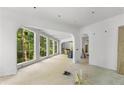 Bright, open living area with large windows and graceful archways at 1176 Lullwater Ne Rd, Atlanta, GA 30307