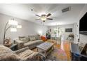Bright and airy living room with hardwood floors, a ceiling fan, and a cozy seating area at 268 Cottonwood Creek Cir, Canton, GA 30114