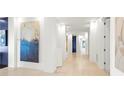 Hallway with white walls, stone floors, recessed lighting, and an array of modern artwork at 2881 Peachtree Ne Rd # 2304, Atlanta, GA 30305