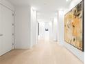 Neutral hallway with white walls, stone flooring, recessed lights and large abstract artwork at 2881 Peachtree Ne Rd # 2304, Atlanta, GA 30305