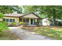Charming single-story home featuring a cozy front porch and a neatly manicured front yard at 2981 Judylyn Dr, Decatur, GA 30033