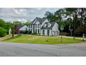 Corner lot home with manicured lawn, mature trees, and three car garage at 303 Sedgewick Trl, Lawrenceville, GA 30044