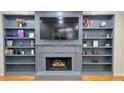 Fireplace flanked by bookcases and mounted TV at 303 Sedgewick Trl, Lawrenceville, GA 30044
