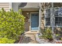 Close up of a blue front door framed by lush landscaping and a brick walkway at 3285 Long Iron Pl, Lawrenceville, GA 30044