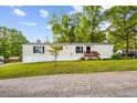 Single story home with a well-manicured lawn, and a small front deck at 101 Olympic Ct, Fayetteville, GA 30214