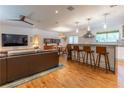 Spacious open-concept living room and kitchen featuring a large sofa, breakfast bar, and contemporary lighting at 287 West Wind Dr, Lilburn, GA 30047