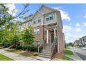 Attractive townhome with brick facade, landscaped front yard, and welcoming staircase to the entrance at 4181 Integrity Way, Powder Springs, GA 30127