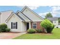 Charming single-story home with brick and siding, featuring a well-manicured lawn and inviting curb appeal at 220 Turnstone Rd, Stockbridge, GA 30281