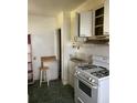 A kitchen with white cabinets, a vintage stove, and green tile flooring at 2689 Knox Ne St, Atlanta, GA 30317