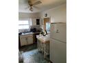 A kitchen featuring white cabinets, appliances, and a table in the center at 2689 Knox Ne St, Atlanta, GA 30317