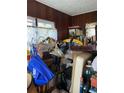 A cluttered room with wood-paneled walls and a window with sheer curtains at 2689 Knox Ne St, Atlanta, GA 30317