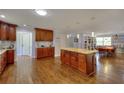 Bright kitchen with wood cabinets, granite countertops, stainless steel appliances, and an open flow to other rooms at 2944 Berry Rd, Loganville, GA 30052